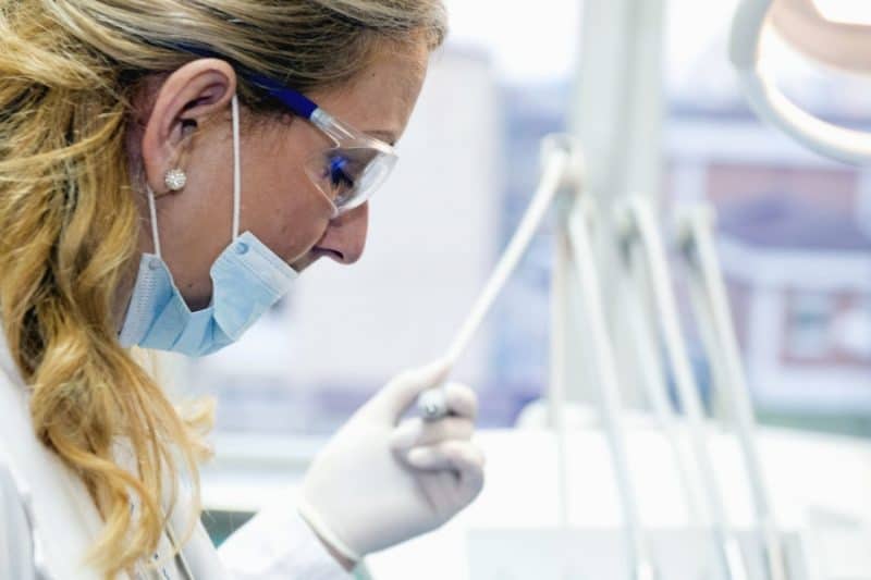 A female dentist with dentistry tools in her hand