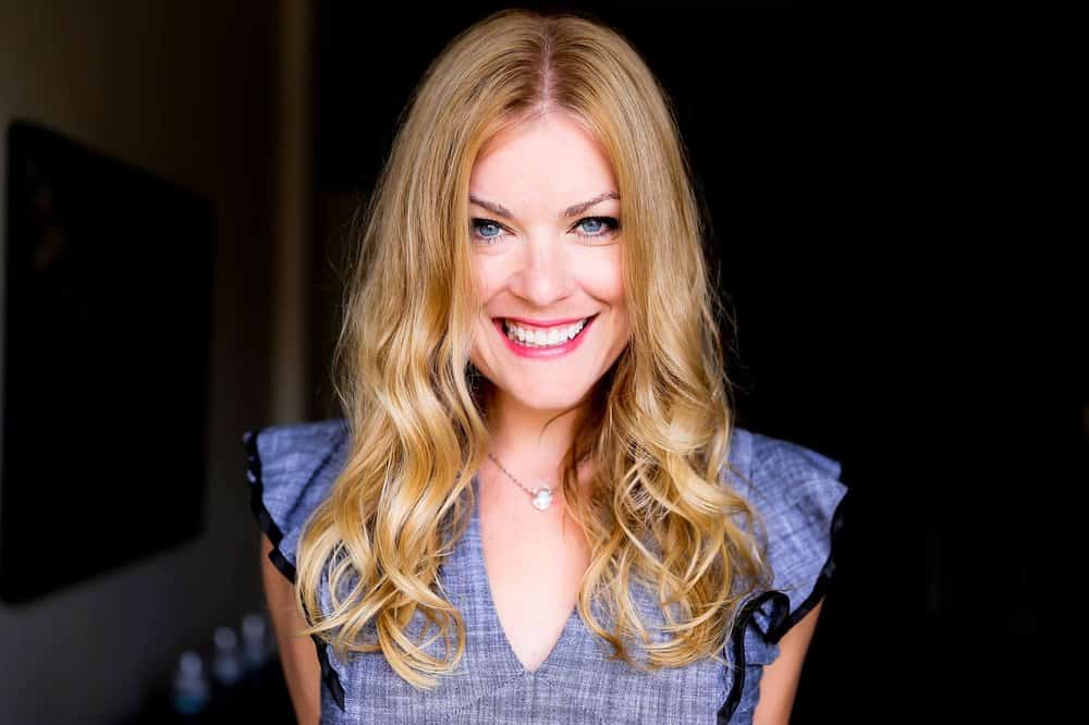 Woman with blonde hair and white teeth smiling