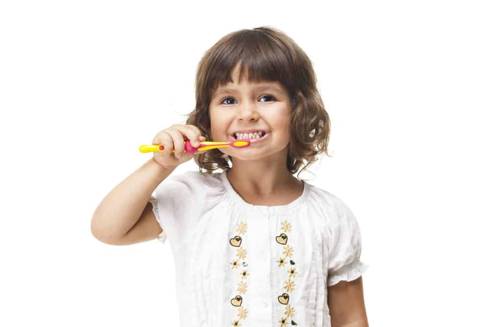 Young girl brushing her teeth